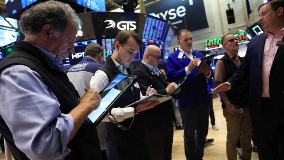 Traders work on the floor of the New York Stock Exchange (NYSE) in New York. AFP/Timothy A Clary