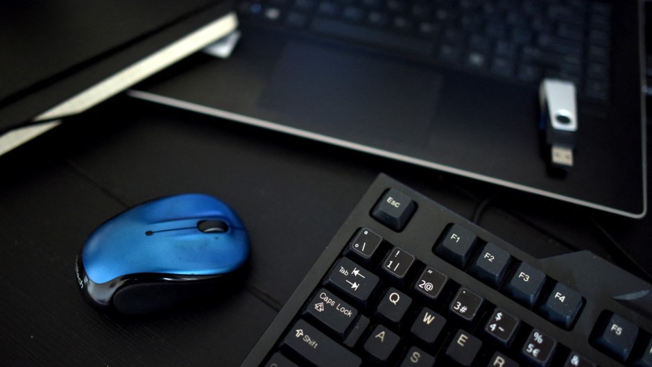 File: A desk with a keyboard, a mouse and a laptop. AFP