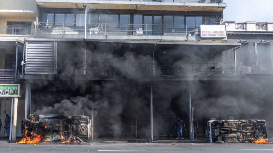 Cars are set alight after clashes erupt between protesters and foreign nationals in Durban on October 8, 2026.