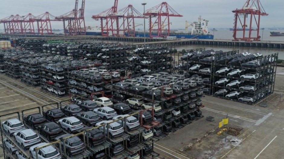 Chinese-made cars including BYD, BAIC, Jetour, Lynk & Co, and MG are seen in specialised vehicle racks in preparation for loading onto ships for export. CN-STR/AFP