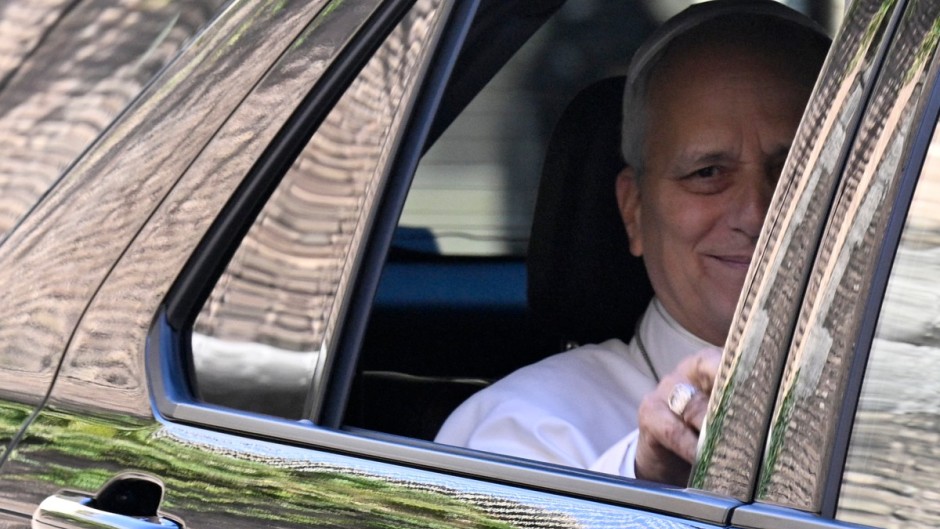 Pope Leo XIV waves from the window of the car as he leaves the Vatican before being admitted to Rome's Gemelli University Hospital. AFP/Tiziana Fabi