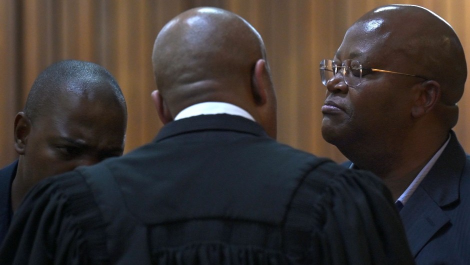 Shaun Abrahams speaks with his two clients Kabelo John Matsepe and Mamone Daniel Msiza at the Pretoria High Court. Gallo Images/Beeld/Deaan Vivier