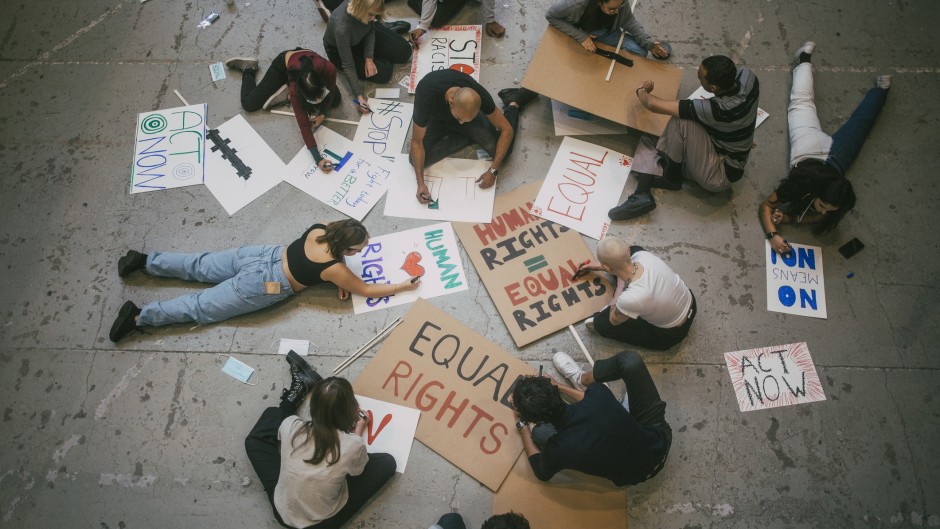Protesters with posters for human and equal rights. GettyImages/Maskot