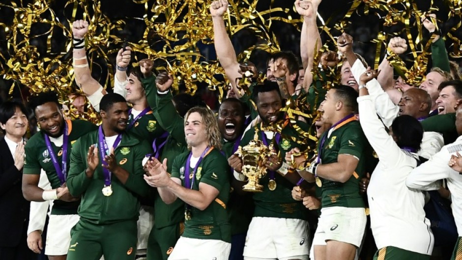 Captain Siya Kolisi (C) holds the Webb Ellis Cup after South Africa beat England in the 2019 Rugby World Cup final in Japan