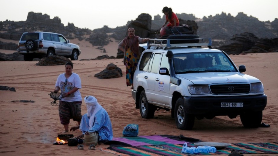Local tour guides set up camp in the desert near the oasis town of Djanet in southeastern Algeria