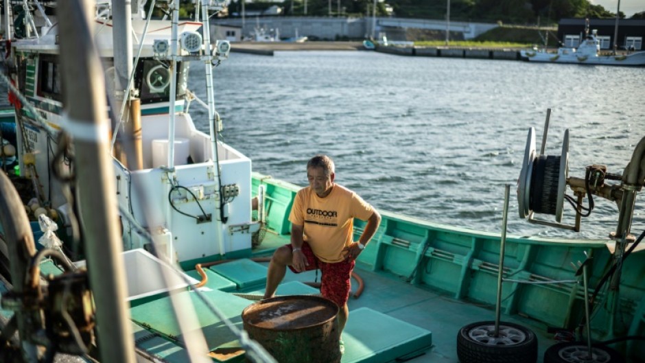 Fisherman Haruo Ono stands on one of his fishing boats. Japan's government will decide on Tuesday about the release of treated water from the crippled Fukushima nuclear plant nearby