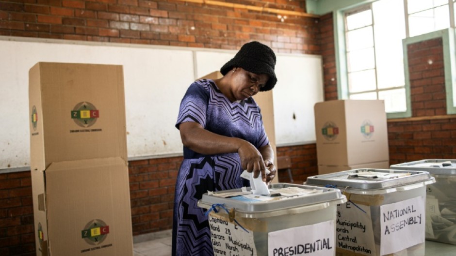 A voter casts her ballot on Thursday -- voting was extended to a second day, purportedly because of delays in printing ballot papers