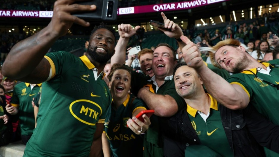 South Africa captain Siya Kolisi celebrates with fans after the Springboks' record 35-7 win over New Zealand at Twickenham