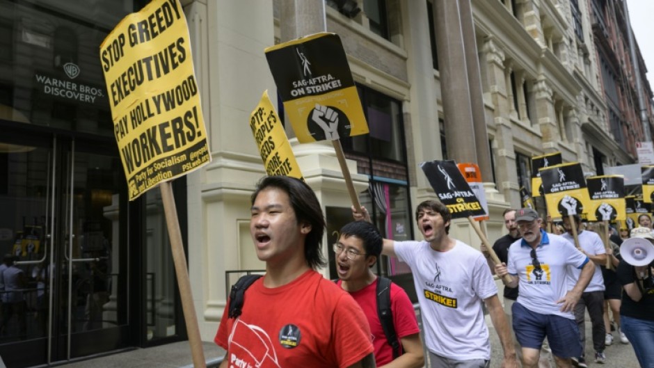 Screen Actors Guild members walk a picket line outside of Warner Bros. Discovery on August 10, 2023, in New York City