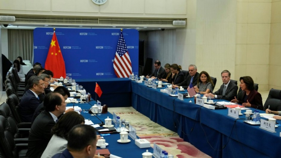 US Commerce Secretary Gina Raimondo (R) met with Chinese Minister of Commerce Wang Wentao (centre-L) in Beijing on Monday