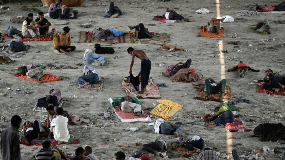 Homeless people take rest under a bridge to get respite from the heat on a hot summer afternoon in New Delhi
