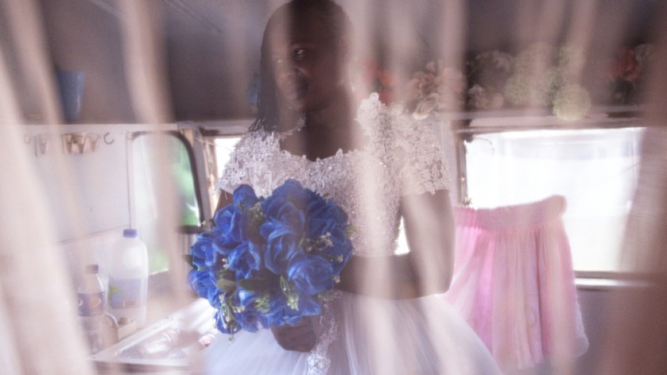 The big day: Bride-to-be Memory poses for a portrait after getting fitted for her wedding gown