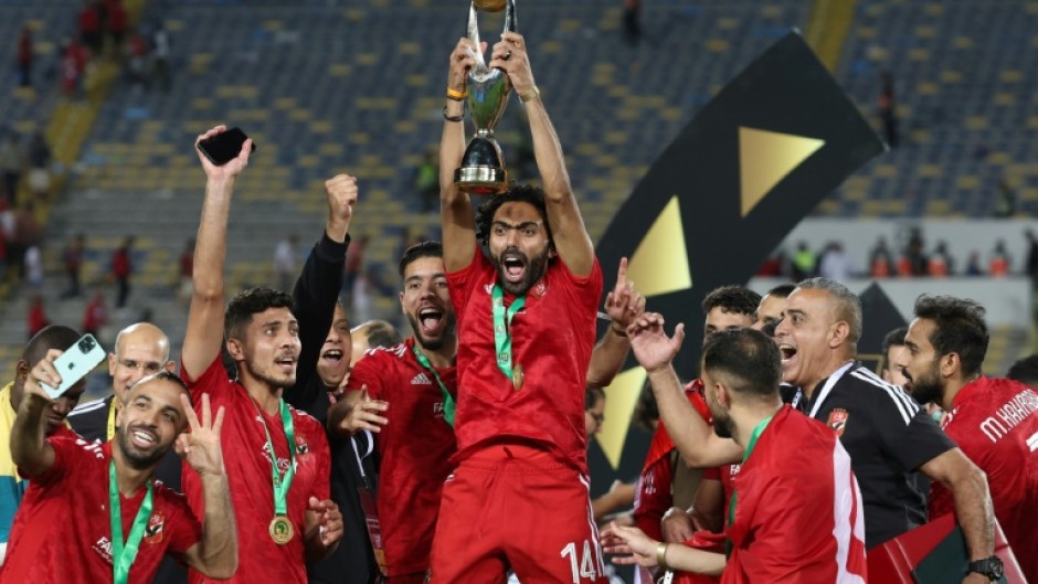 Hussein el Shahat (C) holds the CAF Champions League trophy after Al Ahly of Egypt defeated Wydad Casablanca of Morocco in the 2023 final.
