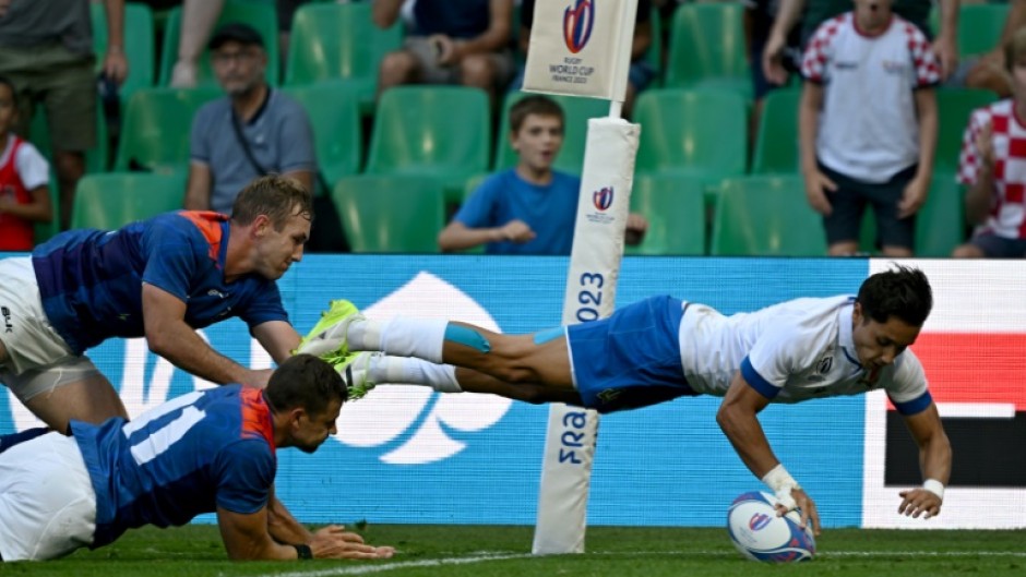 Wing Ange Capuozzo (right) dives over the line to score Italy's fourth try against Namibia