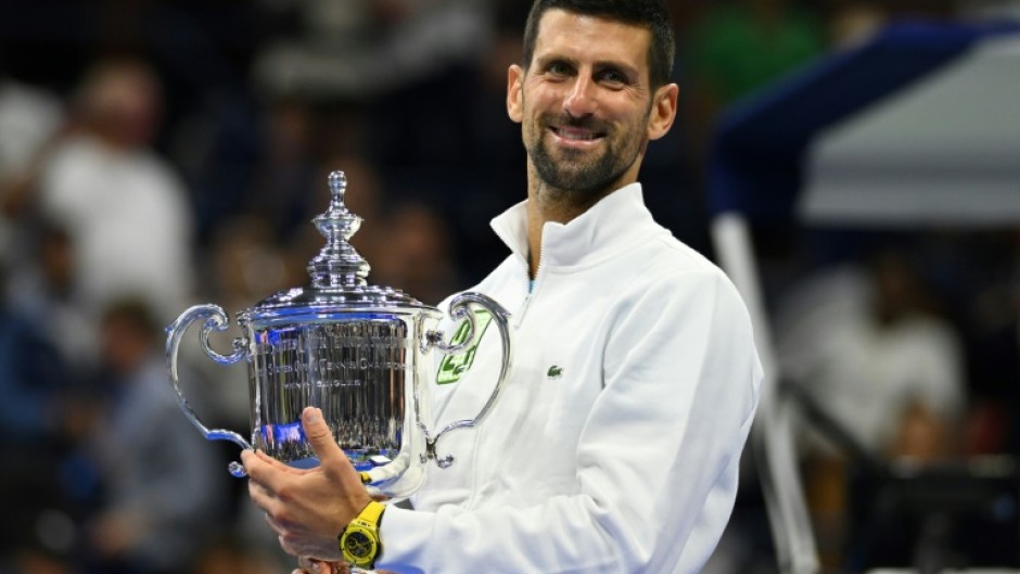 Novak Djokovic poses with the US Open trophy after winning it for the fourth time