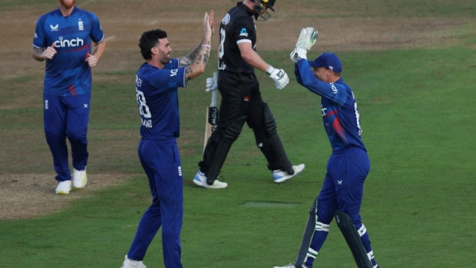 In the wickets - Reece Topley celebrates his dismissal of New Zealand's Glenn Phillips (2R) with England captain Jos Buttler (R) during the second ODI at Southampton