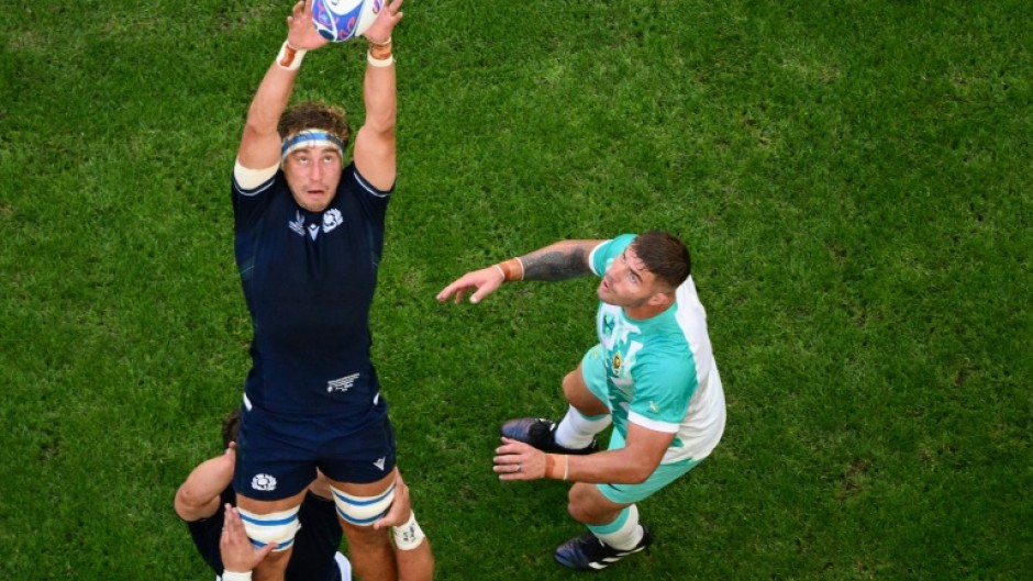 Scotland's flanker and captain Jamie Ritchie (L) grabs the ball in a line out as South Africa's hooker Malcom Marx looks on