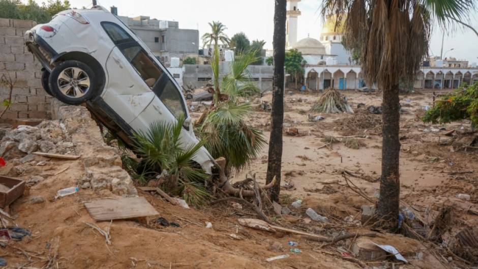 Vehicles are buried in mud and rubble in the aftermath of a devastating flood in eastern Libya's city of Derna