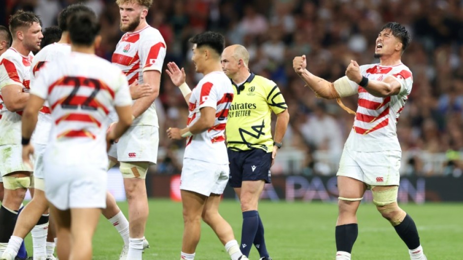 Japan's number eight and captain Kazuki Himeno (R) celebrates victory over Samoa