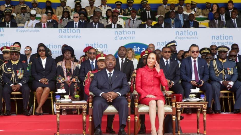 Gabon's ousted president Ali Bongo Ondimba, who ruled the oil-rich country for 14 years, and his wife Sylvia Bongo at a parade to mark independence day in 2019