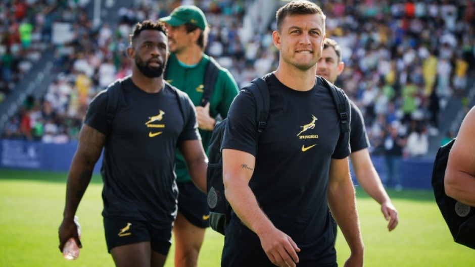 South Africa fly-half Handre Pollard (R) and South Africa captain Siya Kolisi (L)