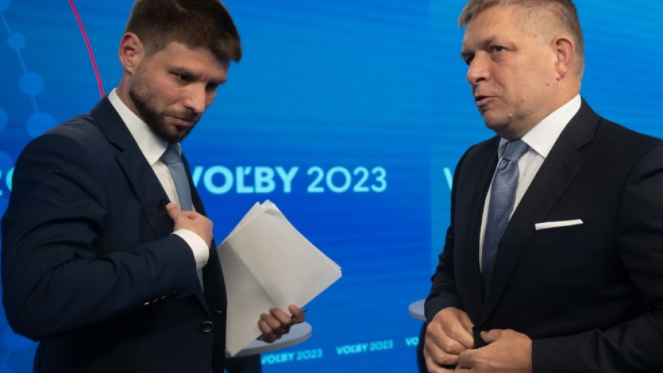 The Progressive Slovakia party's Michal Simecka (l) and Smer-SD leader Robert Fico chat after a televised electoral debate this week 