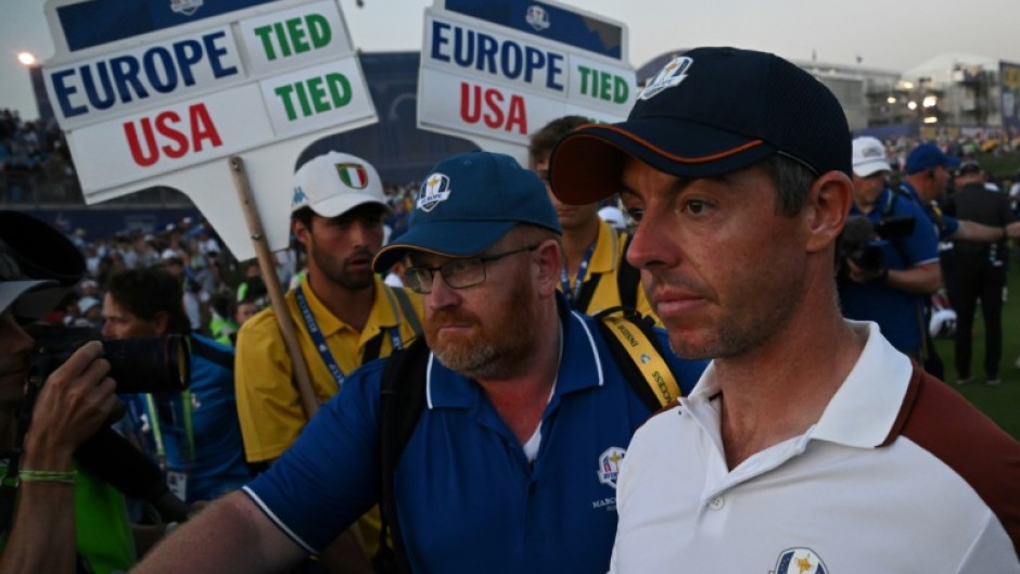 Angry: Rory McIlroy leaves the 18th green 