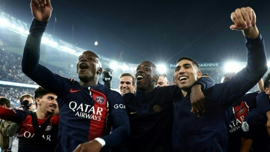 PSG's Ousmane Dembele (C) and Achraf Hakimi (R) celebrate after a 4-0 win over Marseille at the Parc des Princes on September 24, 2023