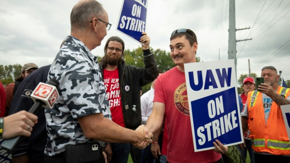 United Auto Workers President Shawn Fain greets UAW members as they strike the General Motors Lansing Delta Assembly Plant in September 2023