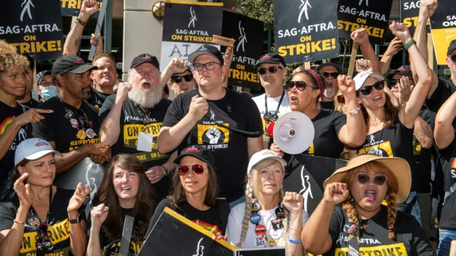 Some of the SAG-AFTRA negotiating committee address members at the picket line outside Warner Brothers offices in Burbank, California