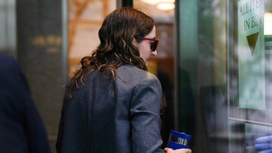 Sam Bankman-Fried's former girlfriend, Caroline Ellison, walks through security at Manhattan Federal Court on October 10, 2023, in New York
