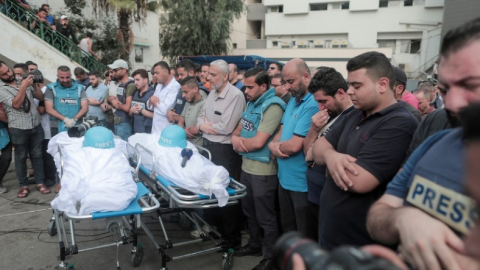 Mourners attend the funeral of fellow journalists Said al-Taweel and Mohammed Sobboh, who were killed in an Israeli airstrike on Gaza City 
