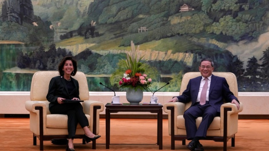 China's Premier Li Qiang (R) speaks with US Commerce Secretary Gina Raimondo in Beijing in August 2023