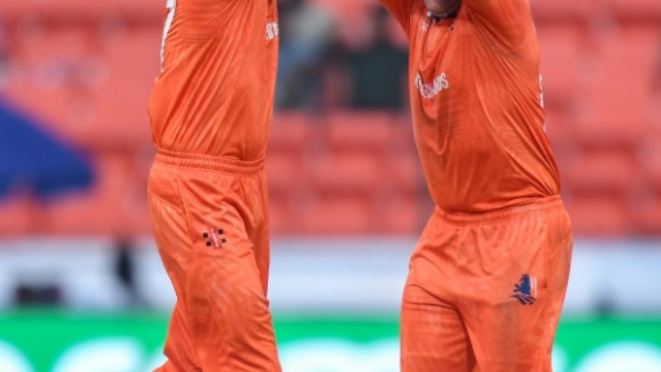 That's out: Netherlands' Paul van Meekeren (left) celebrates after taking the wicket of New Zealand's Daryl Mitchell in Hyderabad