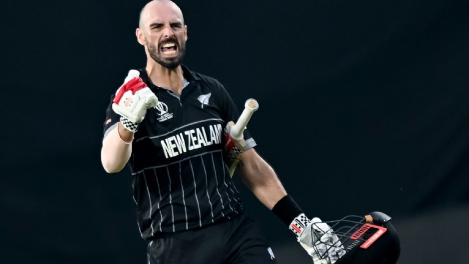 Ton up: New Zealand's Daryl Mitchell celebrates after scoring a century against India on Sunday 