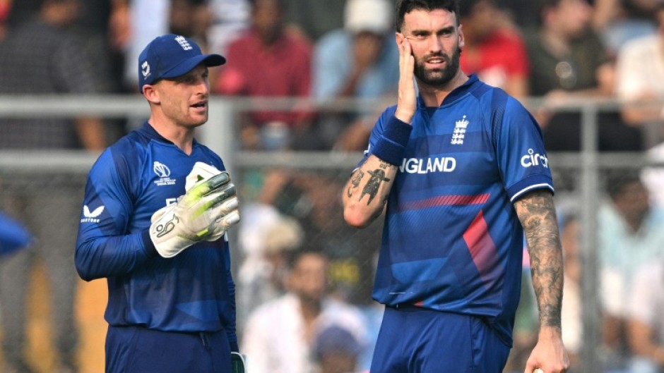 All over: England captain Jos Buttler (left) speaks with Reece Topley 