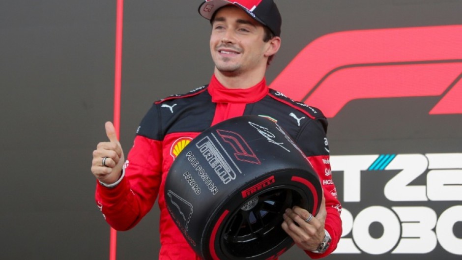 Ferrari's Monegasque driver Charles Leclerc celebrates winning the pole position after the qualifying session for the Formula One Mexico Grand Prix at the Hermanos Rodriguez racetrack in Mexico City on October 28, 2023.