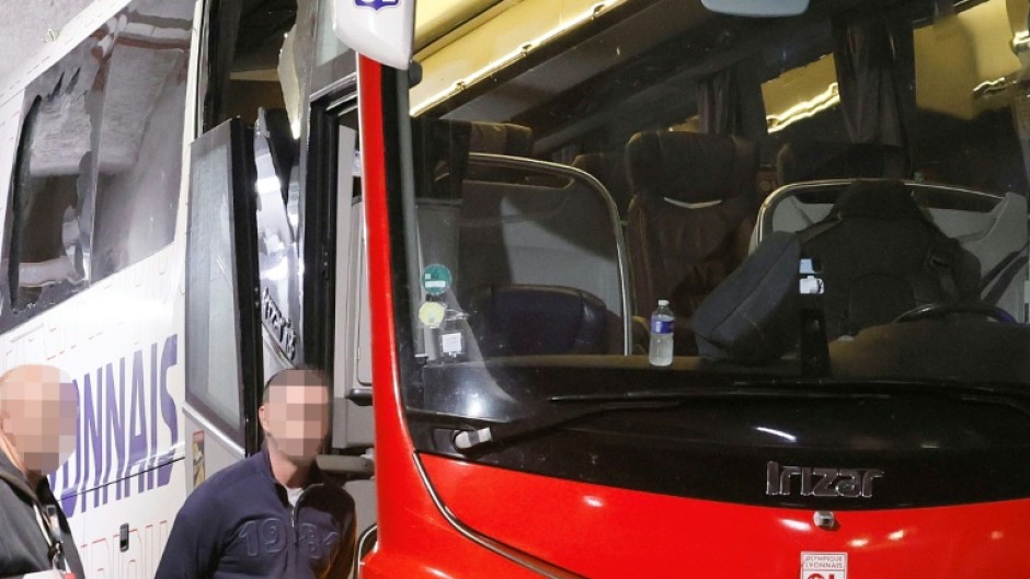 The smashed window of Lyon's team bus is visible after stones were thrown as it travelled to Marseille's Velodrome stadium
