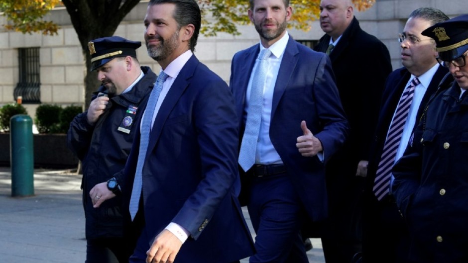 Donald Trump, Jr (2nd L) and Eric Trump (C) have both testified in their father's fraud trial