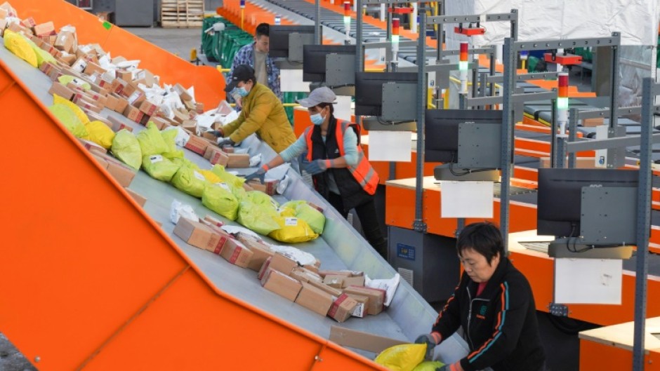 Workers sort packages for delivery ahead of the Singles' Day sales bonanza in China
