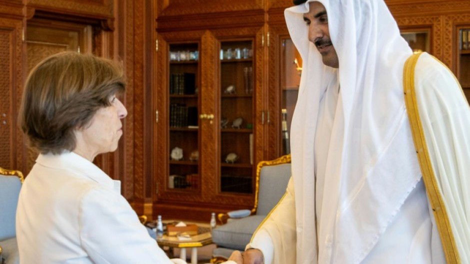 Emir Sheikh Tamim bin Hamad al-Thani welcomes French Foreign Minister Catherine Colonna at the Royal Palace in Doha