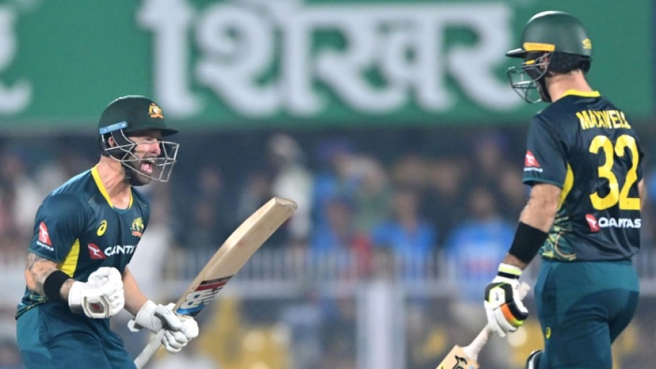 Australia captain Matthew Wade (L) celebrates with Glenn Maxwell after winning the third Twenty20 international cricket match against India in Guwahati