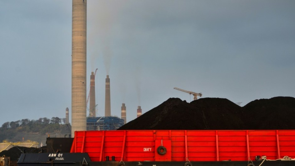 A barge carries coal to the dock next to the Suralaya coal-fired power plant in Cilegon, in Indonesia's Banten province