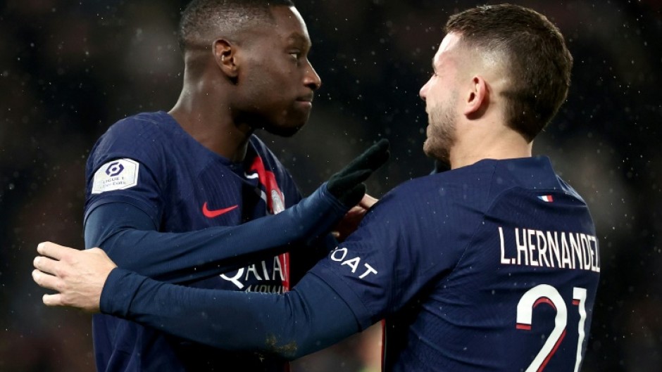 Paris Saint-Germain's Randal Kolo Muani (L) celebrates his winning goal