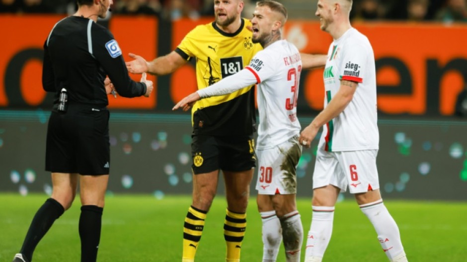 Dortmund forward Niclas Fuellkrug talks with referee Matthias Joellenbeck during his side's 1-1 draw at Augsburg on Saturday