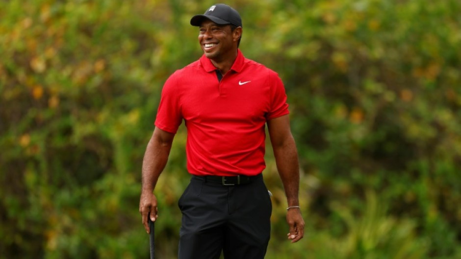 Tiger Woods reacts to a chip-in birdie by his 14-year-old son Charlie on the ninth green during the final round of the PNC Championship