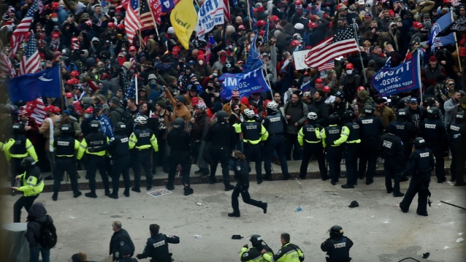 Police hold back supporters of US president Donald Trump outside the US Capitol on January 6, 2021