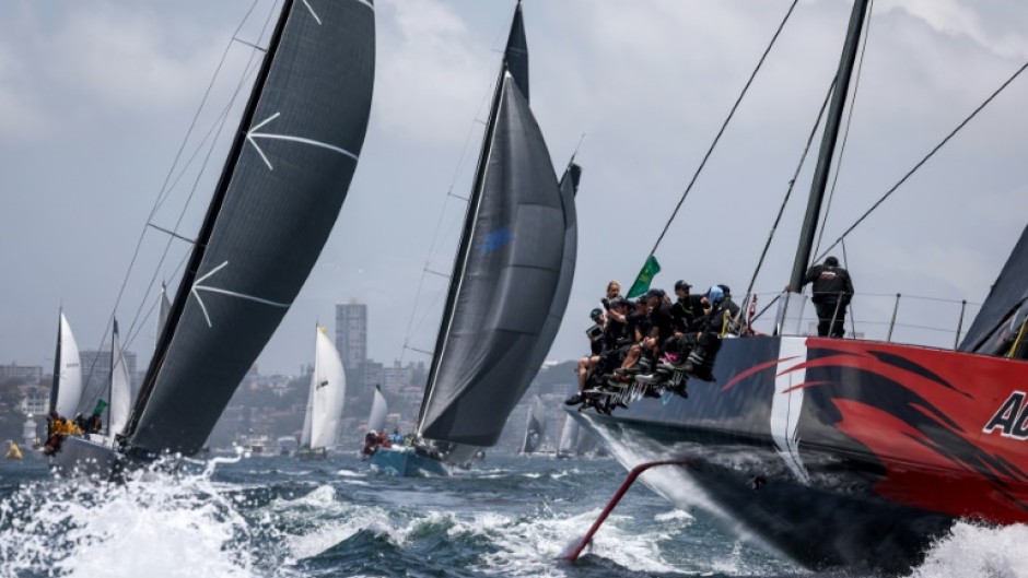 Favourite Andoo Comanche (R) competes during the start of the annual Sydney to Hobart yacht race