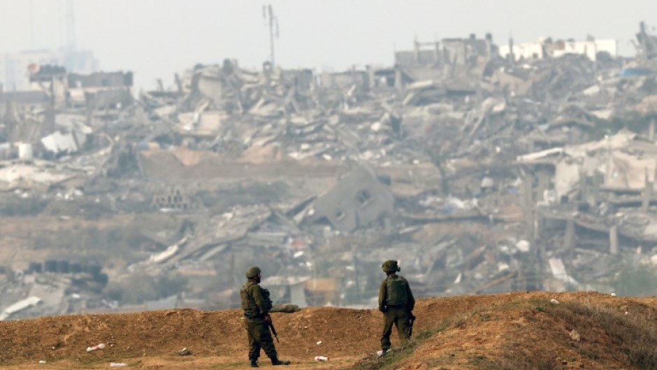 Israeli soldiers patrol along the Israel-Gaza border