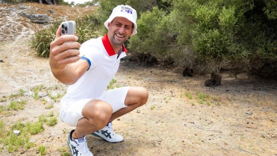 Novak Djokovic taking a selfie with a quokka on Rottnest Island in Australia